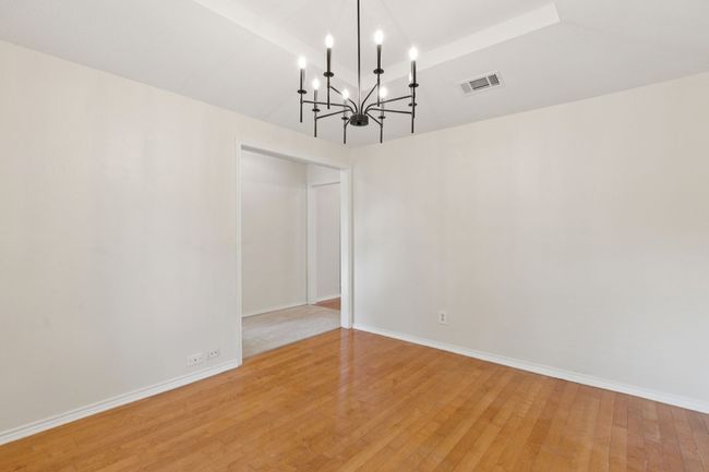 Formal Dining Area with New stylish chandelier and engineered hardwood flooring | Image 7