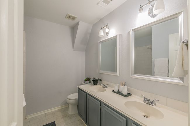Bathroom featuring visible vents, a sink, and toilet | Image 21