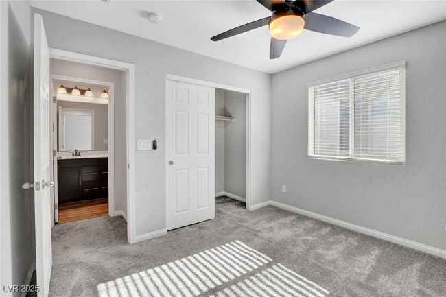 Unfurnished bedroom with carpet flooring, a sink, baseboards, and a closet | Image 37