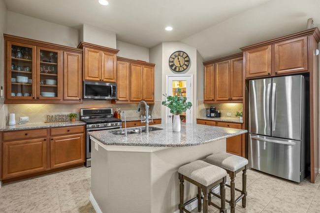 Kitchen boasts high quality finishes throughout - tons of storage and counter prep space PLUS deep, walk-in pantry | Image 7