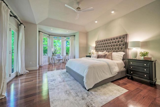 Spacious primary bedroom with natural lighting and private balcony | Image 21
