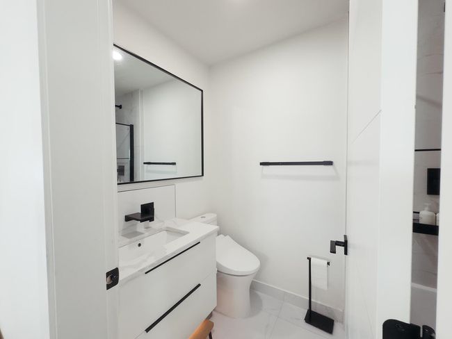 Full bath with baseboards, vanity, toilet, marble finish floors, and a shower | Image 23