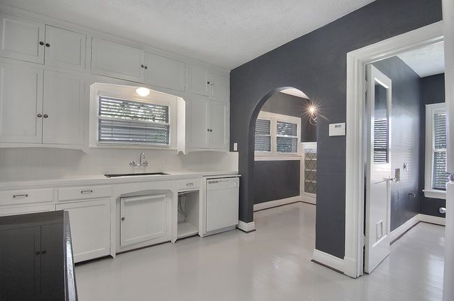 Kitchen with white cabinets, a sink, light countertops, and dishwasher | Image 20