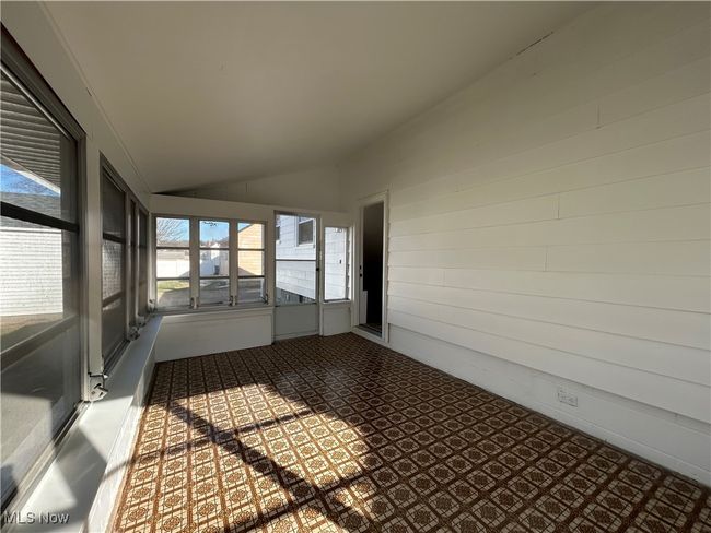 Unfurnished sunroom featuring lofted ceiling | Image 28