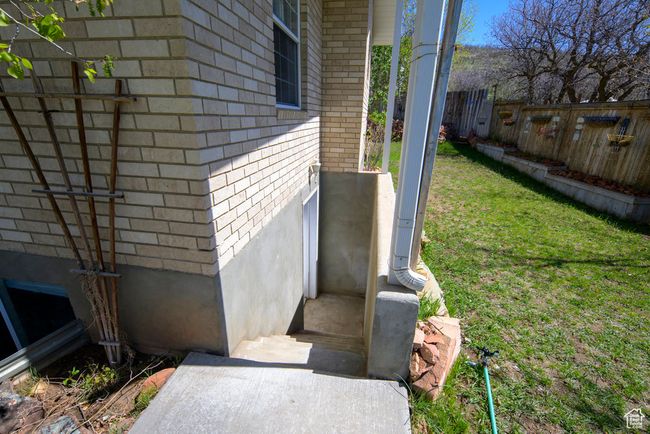 View of side of home with fence and brick siding | Image 47