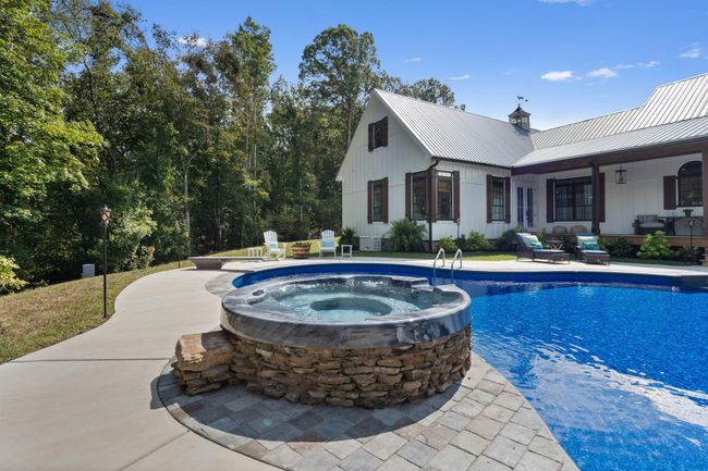 Hot tub with waterfall into pool | Image 23