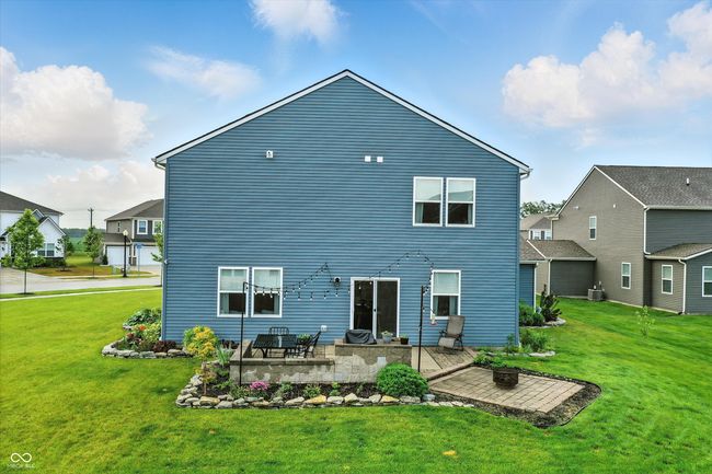 rear view of house featuring a patio area and a yard | Image 39