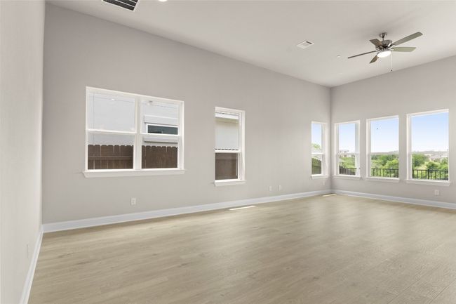 Empty room featuring a ceiling fan, light wood finished floors, and baseboards | Image 15