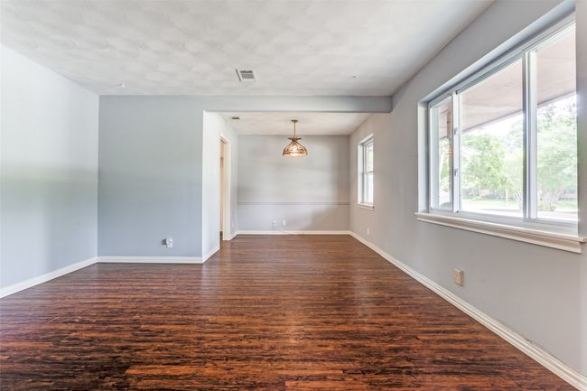Unfurnished room with dark wood-style floors and baseboards | Image 7