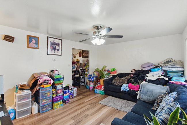 Living room with a ceiling fan and wood finished floors | Image 20