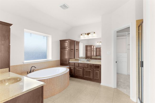Full bathroom featuring tile patterned floors, visible vents, a garden tub, and vanity | Image 32