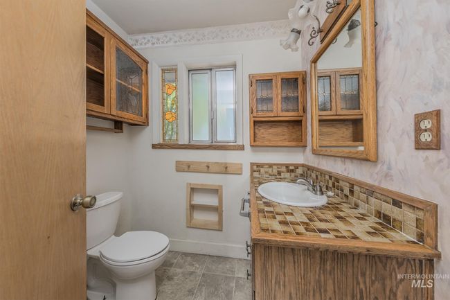 1/2 bath featuring vanity and backsplash | Image 17