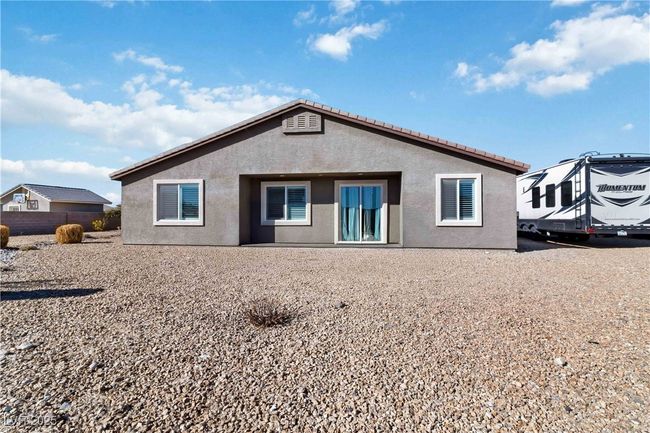 Rear view of house with stucco siding. Some outdoor toys, grill/personal items removed virtually for picture. | Image 40