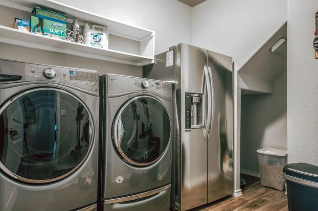 Laundry area with laundry area, dark wood finished floors, and washer and dryer | Image 17