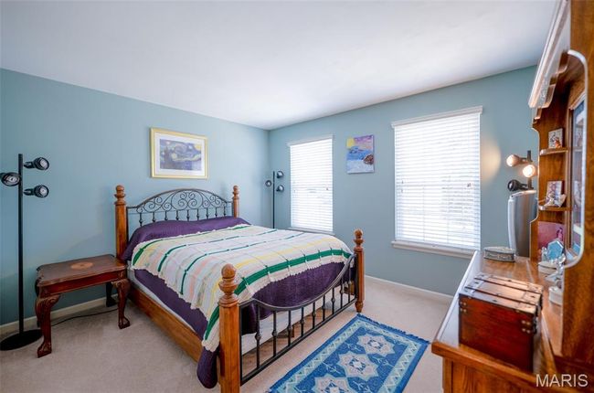 Bedroom with carpet floors and multiple windows | Image 37