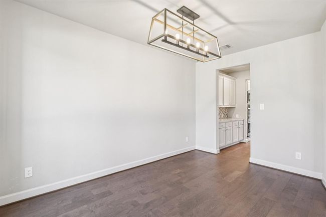 Host elegant dinners in this spacious dining area featuring easy access to the kitchen | Image 5