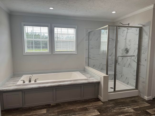 Full bathroom with a garden tub, a marble finish shower, ornamental molding, a textured ceiling, and wood finished floors | Image 21