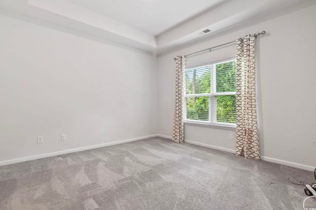 Carpeted spare room featuring baseboards and a raised ceiling | Image 22