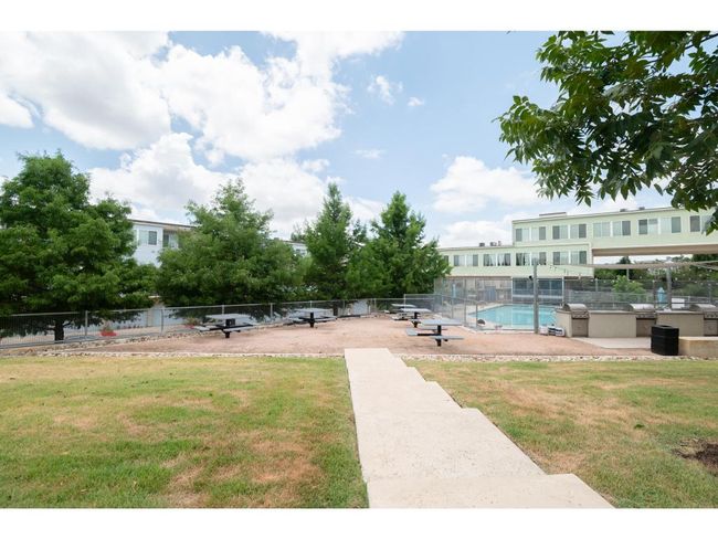 View of community with a swimming pool and exterior kitchen | Image 24