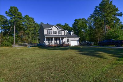 View of front of house with a front lawn and covered porch | Image 1