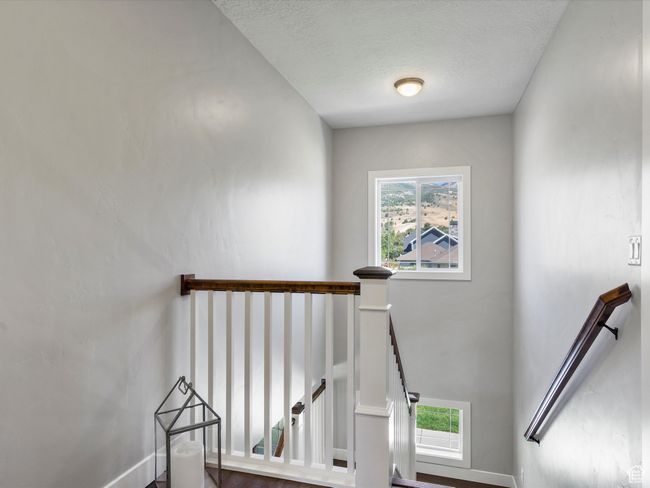 Staircase featuring a textured ceiling | Image 27