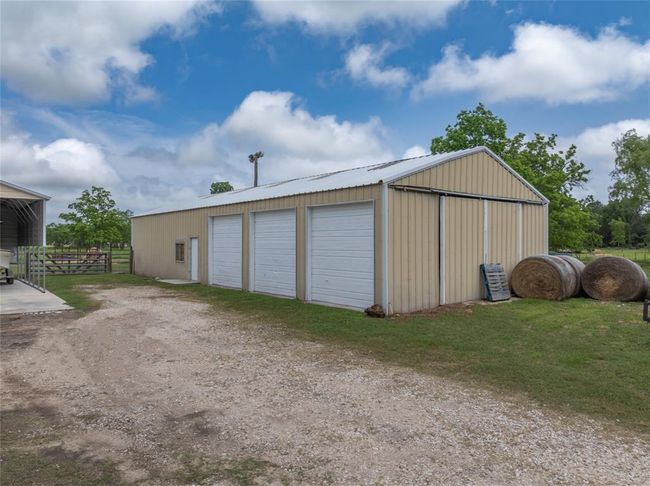 No country property is complete without a large workshop and this one has it all for the hobbyist or small famer! With its impressive features, it offer 3 commercial overhead doors, 2 sliding doors one on each end of shop, 2 entry doors, horse stall & tack room with overhead storage, bonus hobby room with AC unit, there is 3 covered horse/livestock pen with concrete floors, turkey/chicken/quail pens behind the shop | Image 36