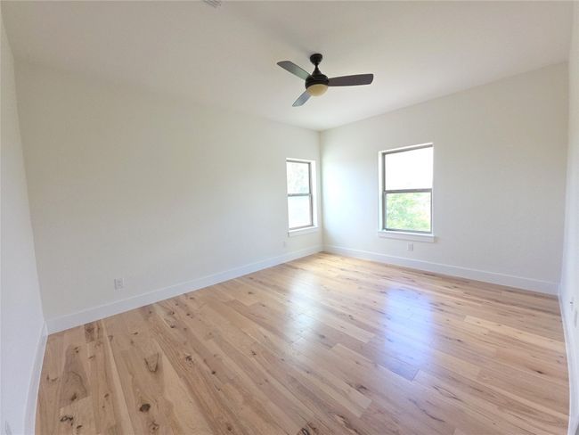 Unfurnished room with light wood-style floors, a ceiling fan, and baseboards | Image 22