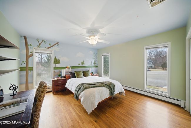 bedroom #2 with painted lake mural , large windows & custom closets. | Image 25