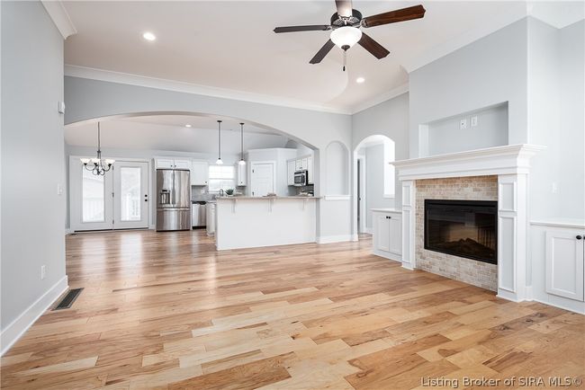 Living room opens to kitchen with a a soaring arch above! | Image 6