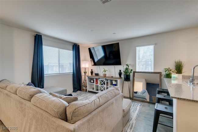 Living room with a healthy amount of sunlight and light wood finished floors | Image 16