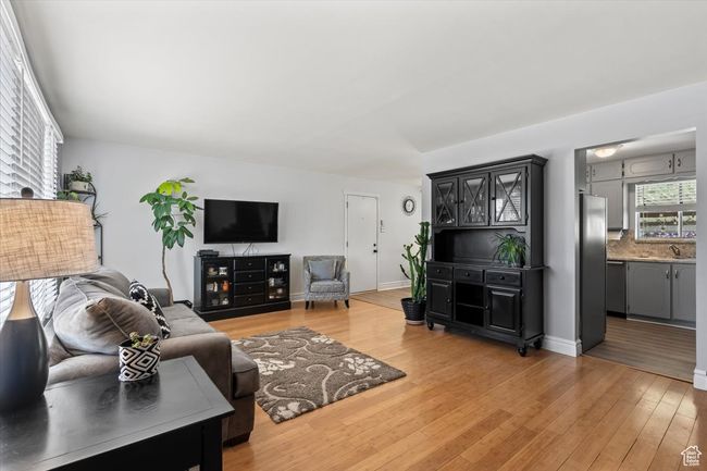 Living area with light wood-type flooring | Image 4
