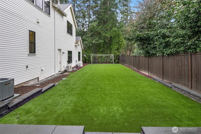 A Side Yard Customized with Turf Perfect for Soccer, Cornhole, or your Own Personal Favorite Summer Game. | Image 40