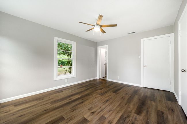Unfurnished bedroom with dark wood-style flooring and ceiling fan | Image 30