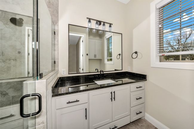 Bathroom featuring baseboards, a stall shower, and vanity | Image 29