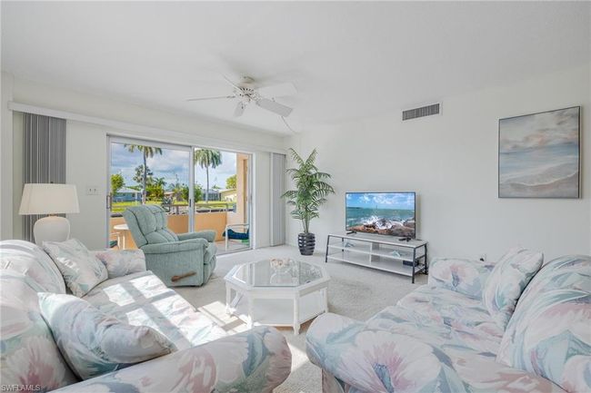 Carpeted living room with ceiling fan | Image 5