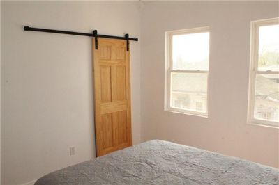 Tin wall w/ barn doors for closet space | Image 2