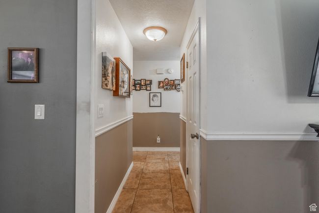 Corridor featuring tile patterned flooring and baseboards | Image 30
