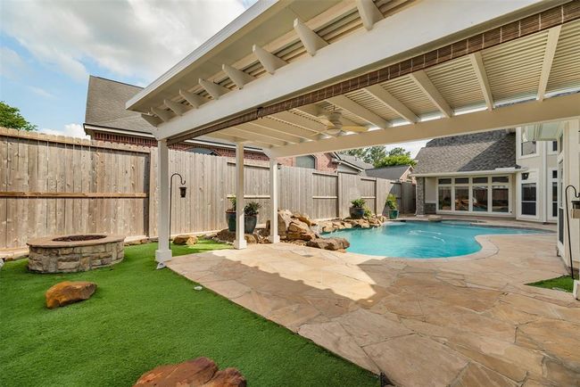 Just beyond, a custom firepit sits on soft turf surrounded by open sky — a cozy, intimate spot for cool evenings under the stars. Toast s’mores with family, share stories with friends, or simply unwind as the flames flicker and the night settles in. | Image 47