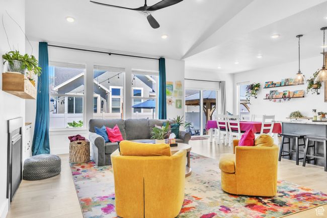 Living room featuring plenty of natural light, wood finished floors, ceiling fan, recessed lighting, and vaulted ceiling | Image 7