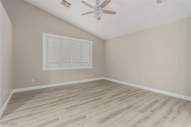 Master bedroom featuring ceiling fan, vaulted ceiling and light wood-style flooring | Image 16