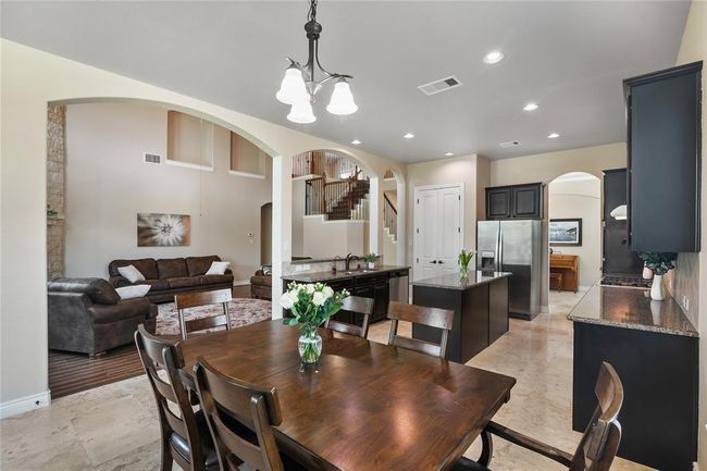 The expansive breakfast area has a harmonious view to the family room and the cherish backyard. | Image 14