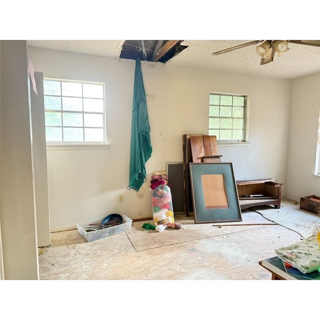 Bedroom 2 featuring multiple windows, and ceiling fan. Bedroom is on front side of house | Image 25