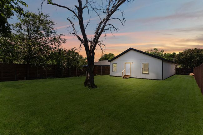 Yard at dusk featuring entry steps and a fenced backyard | Image 30