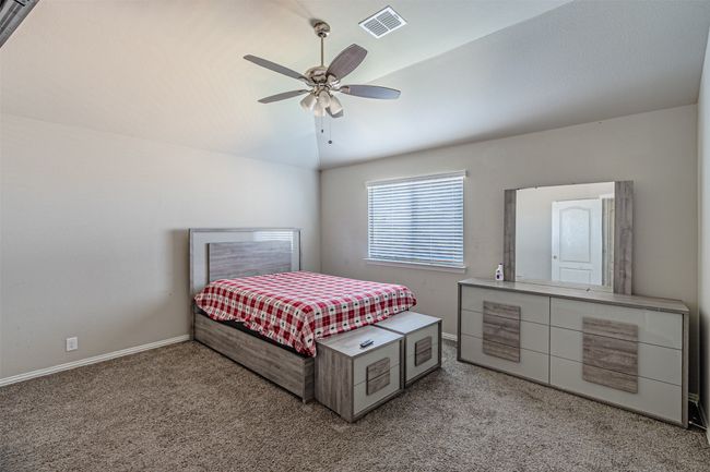 Bedroom featuring light colored carpet, baseboards, and a ceiling fan | Image 37