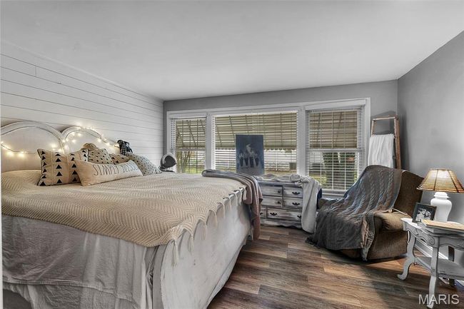 Bedroom with wood finished floors | Image 6