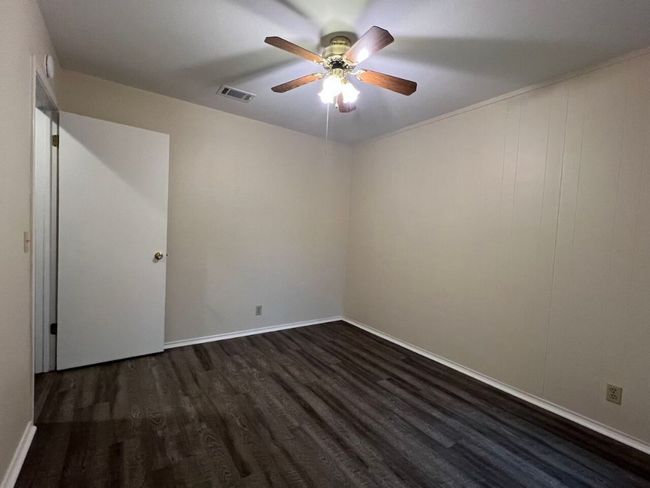 Empty room featuring dark wood finished floors and a ceiling fan | Image 35