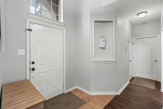 Front entry leading to downstairs secondary bedroom, full bathroom, and laundry room. | Image 4