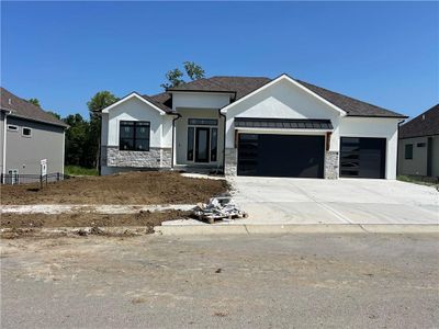 View of front of house with a garage and a front lawn | Image 1