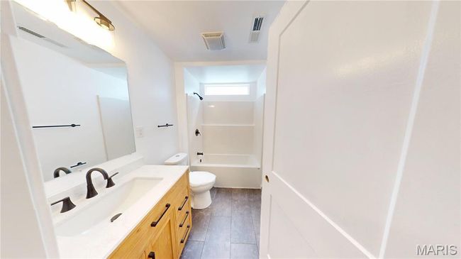 Full bathroom with vanity, shower / washtub combination, toilet, and wood finished floors | Image 22