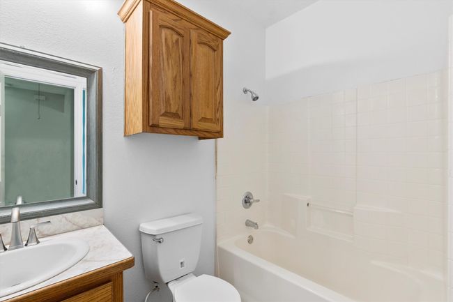 Full bath featuring toilet, bathing tub / shower combination, and vanity | Image 10